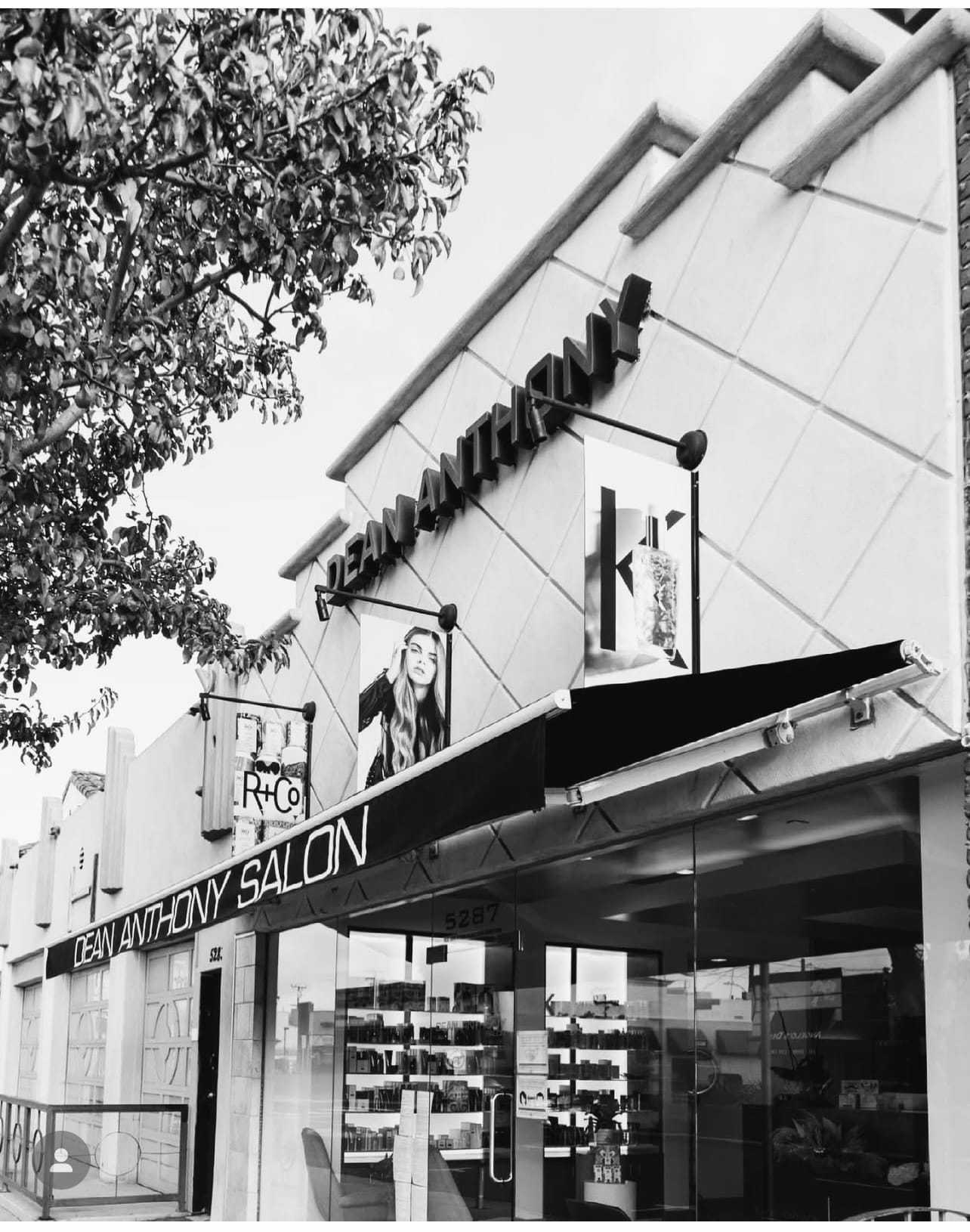 Exterior of Dean Anthony Salon with modern signage and large windows.